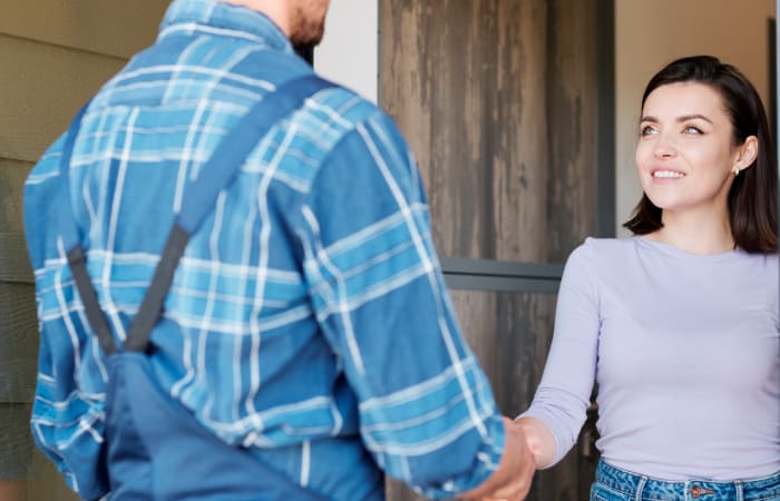 Locksmith shaking customer's hand after a successful job was performed.